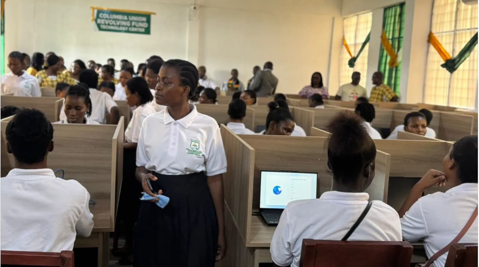 Students in computer lab with instructor demonstrating to class